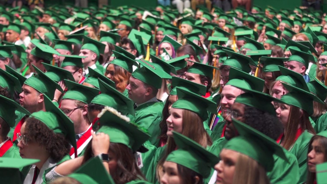 UNT Students in their graduation gowns sitting together