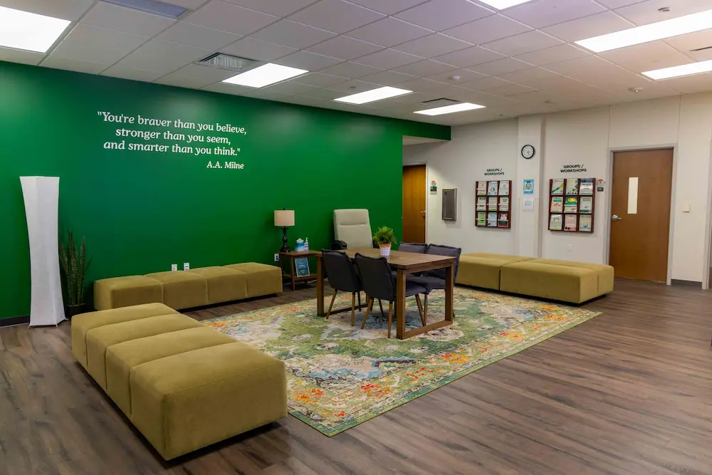 Photo of the lobby of the center for counseling and testing department with green wall tables and couches