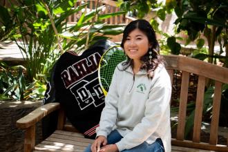 natalie rahija posing for a photo with her letterman and tennis racket