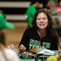 UNT Alumnus smiling and eating lunch