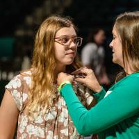 UNT student receiving pin from Legacy family