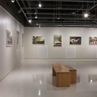 main installation view showing 9 framed photographs hanging on the wall