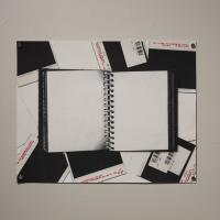 black and white notebook with red markings