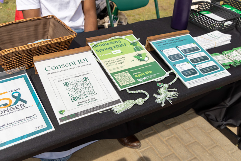 a photo of informational flyers displayed for students to take during sexual assault awareness month. Flyers include information about consent, sexual assault awareness and upcoming events.