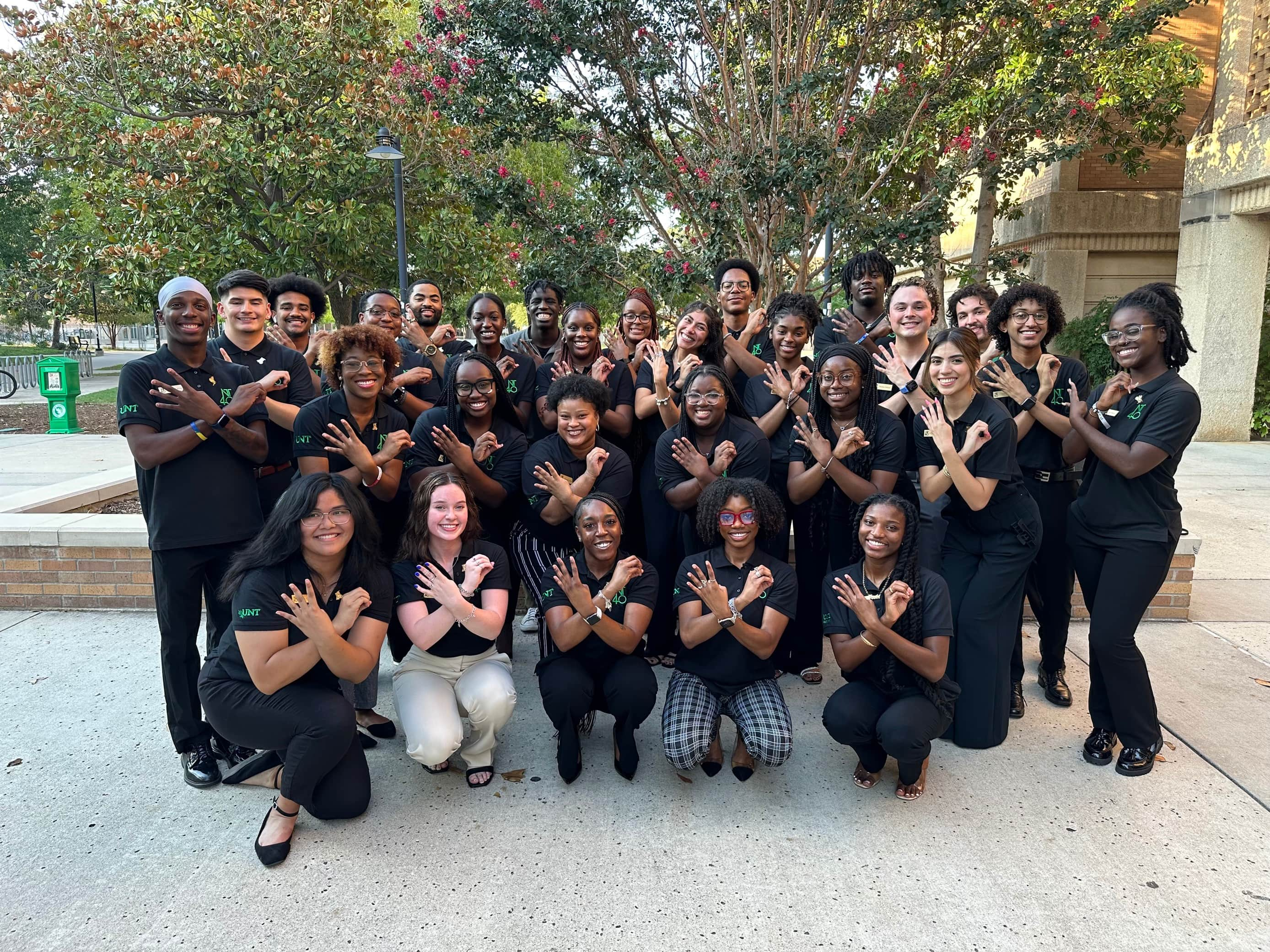 nt40 members showing hand signals for 4 and 0