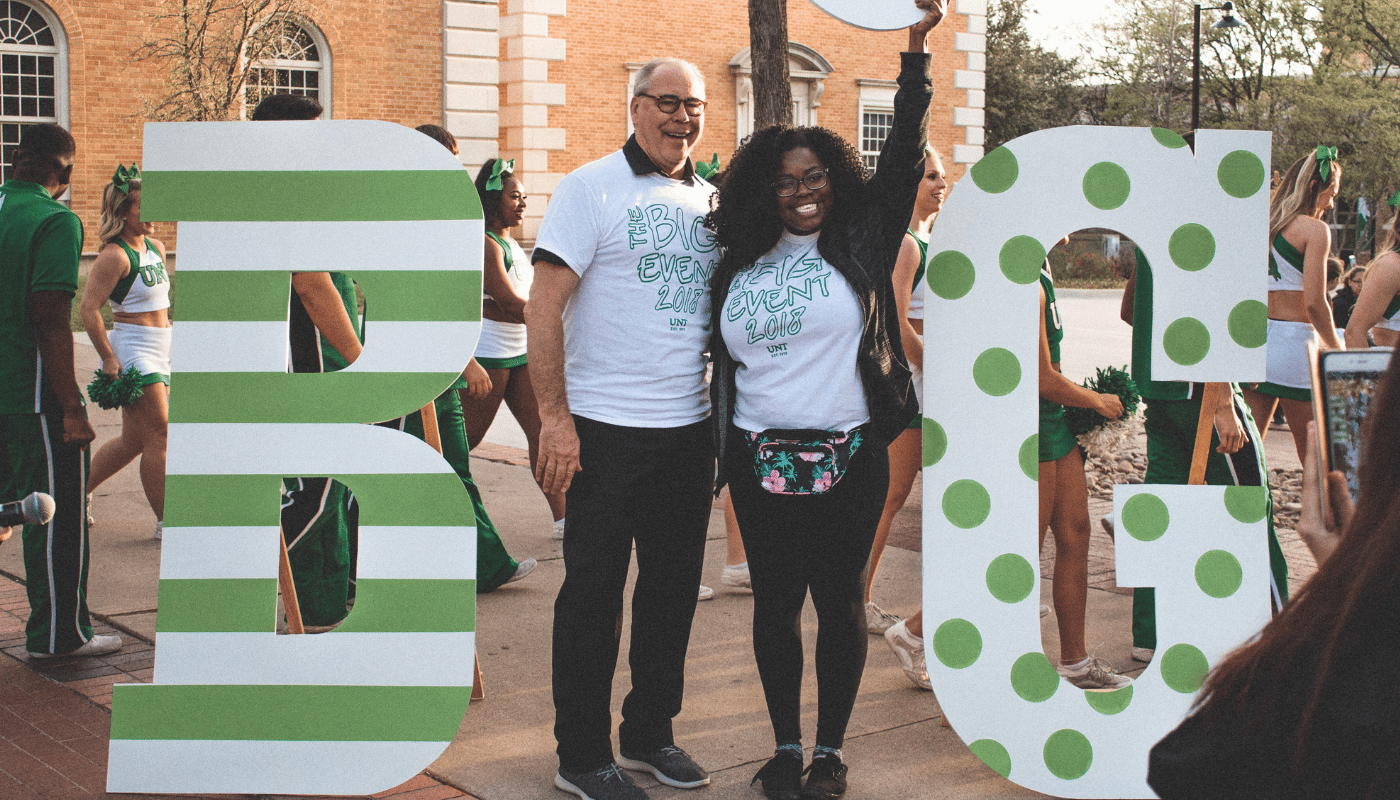 big event sign with two people