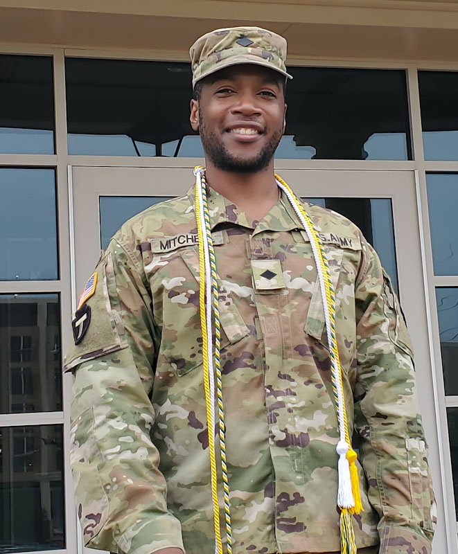 UNT student and fraternity member Dontrell Mitchell poses wearing his honor cords for graduation and Army uniform.