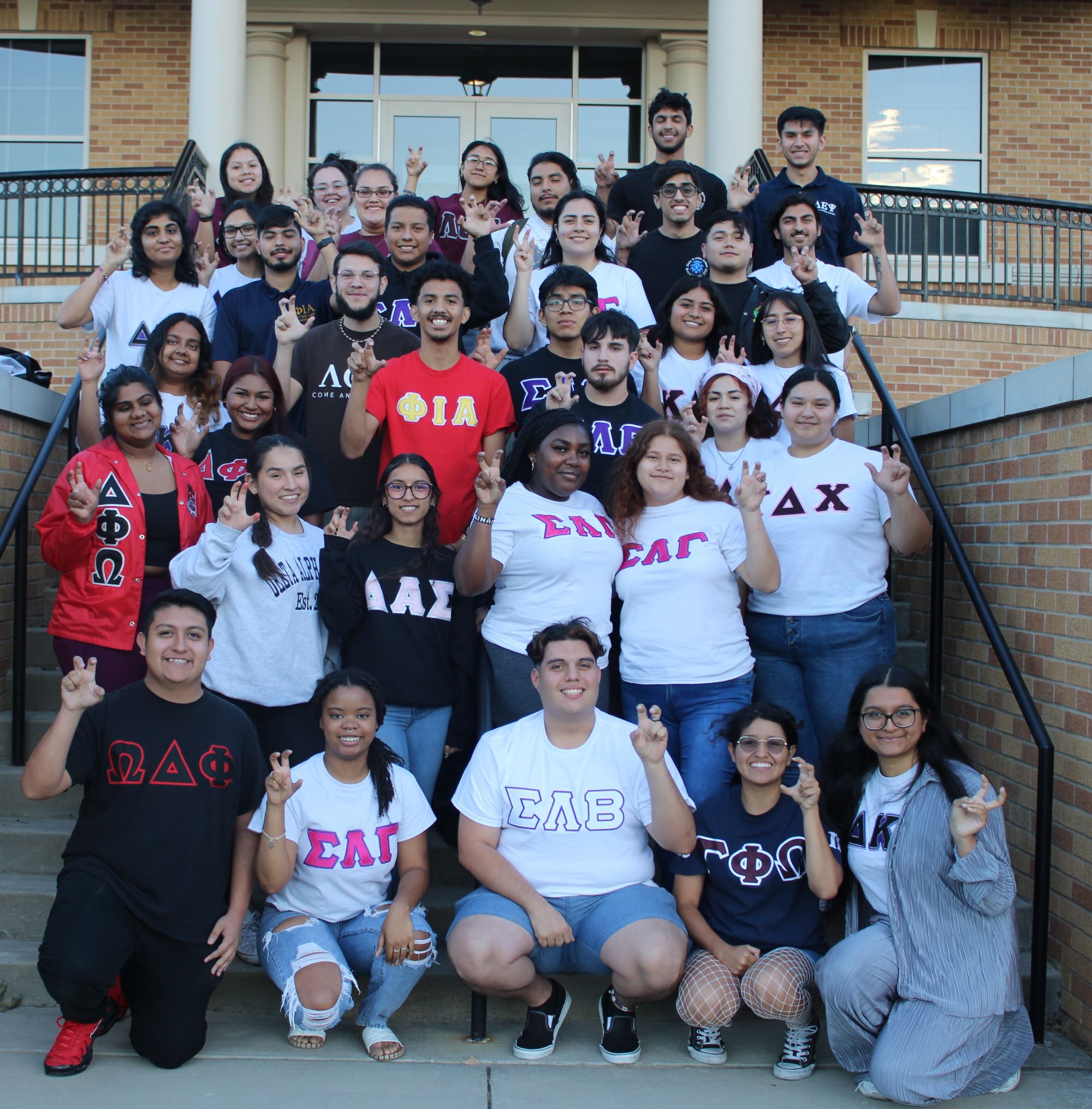 two students planting a plant in soil