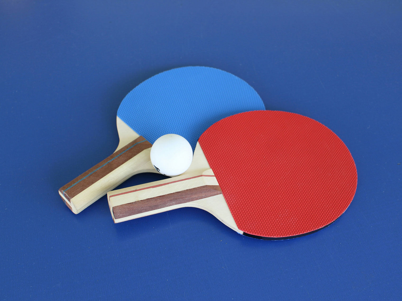 Table tennis paddles on a table tennis table.