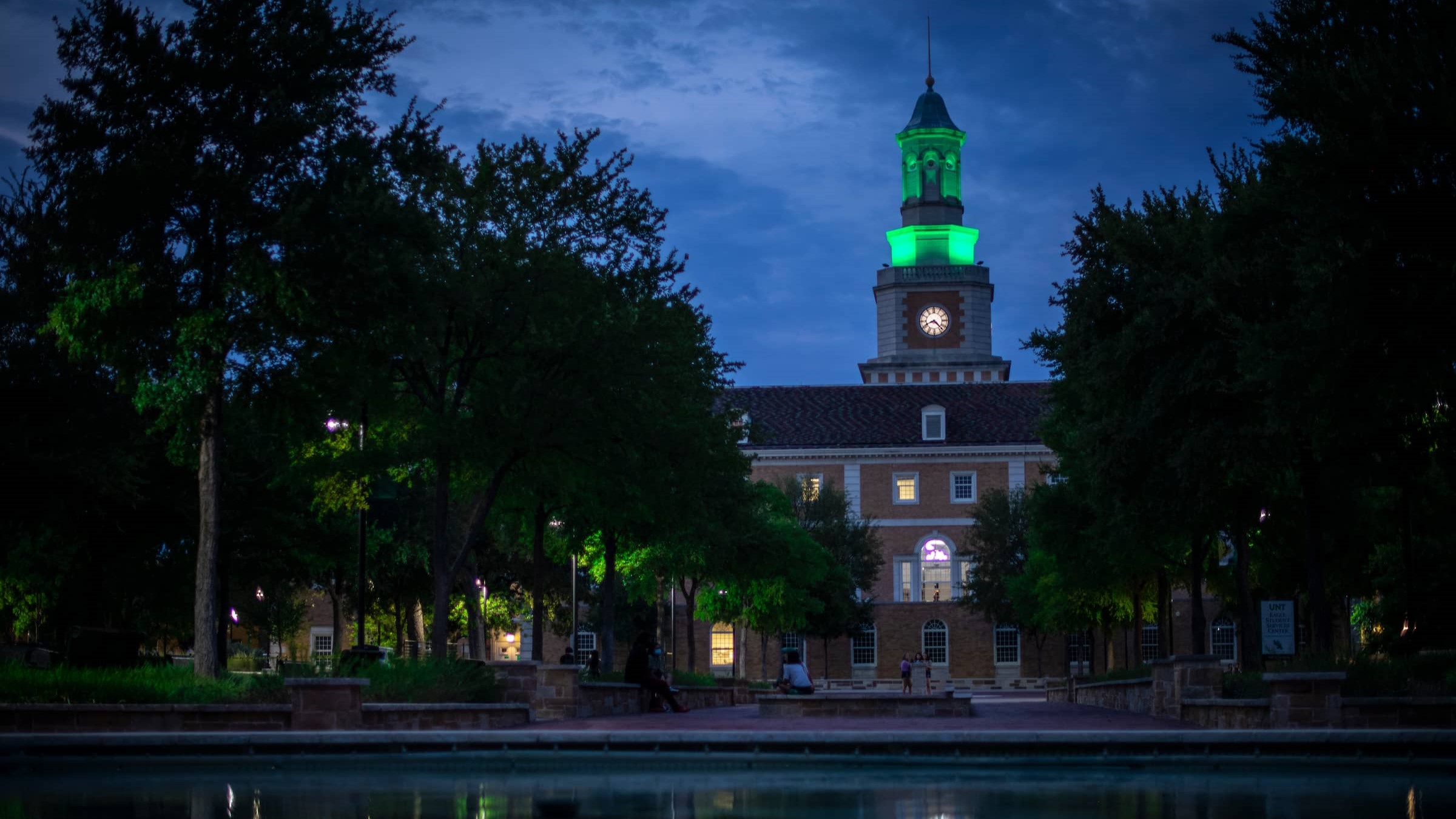 Image of Hurley Administration Building from library mall view at evening.