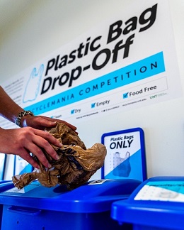 Plastic Bag Being Put Into The Plastic Bag Receptacle 