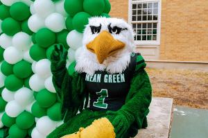 Scrappy does the iconic UNT hand gesture to show his spirit.