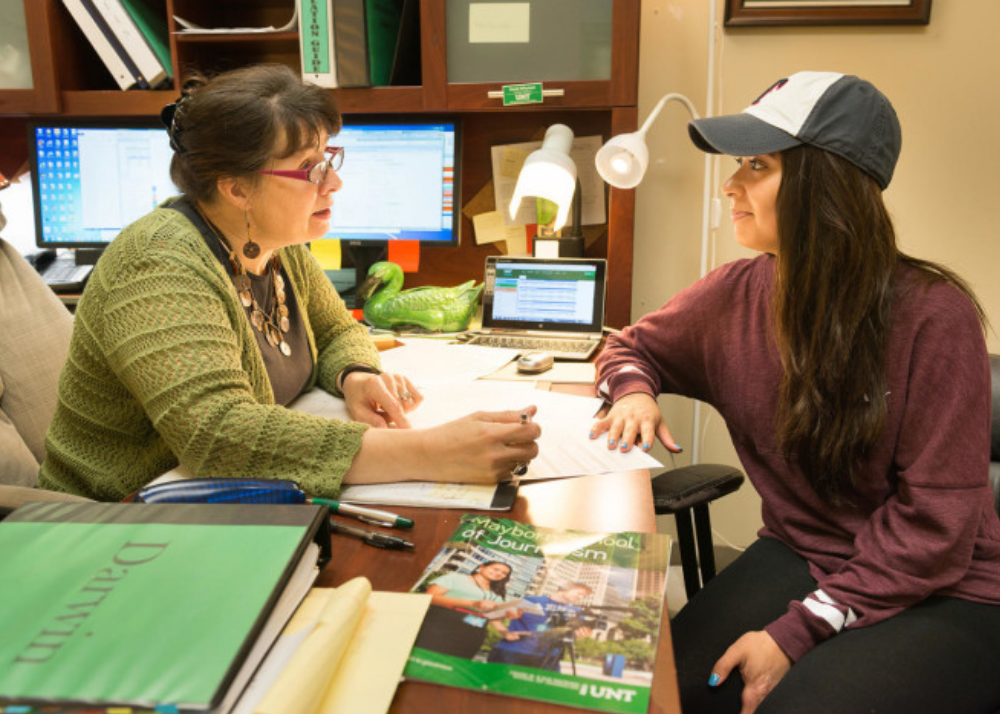 Picture of student meeting with an academic advisor in their office. 