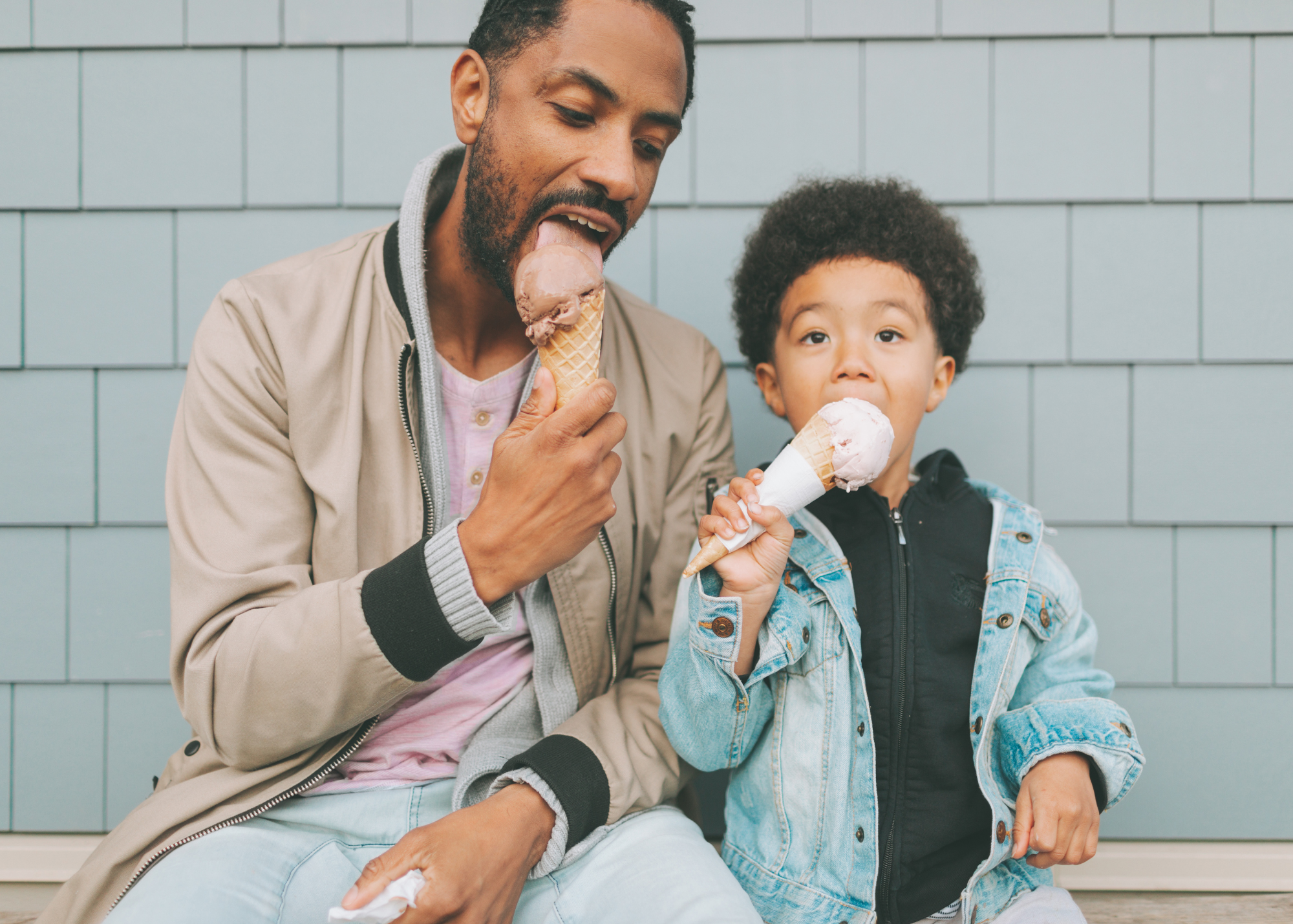 Photo of a dad eating ice cream with his son.