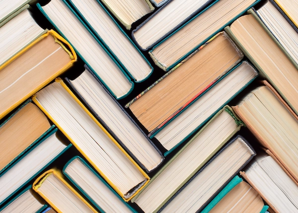 Photo of textbooks stacked on top of each other.