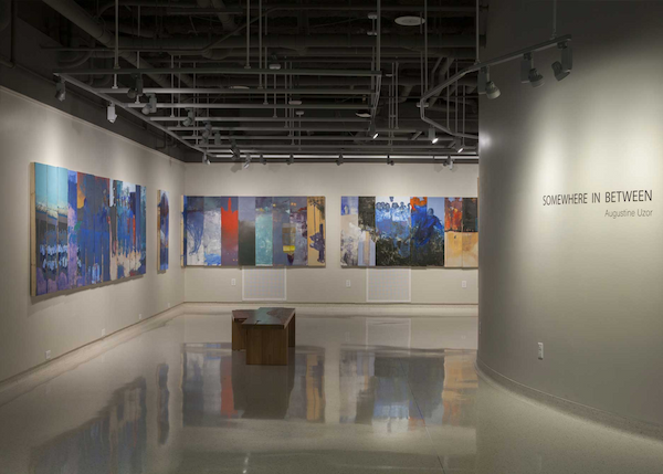 Photo of art work in the Union Art Gallery. The title of the exhibit is Somewhere in Between by Augustine Uzo.