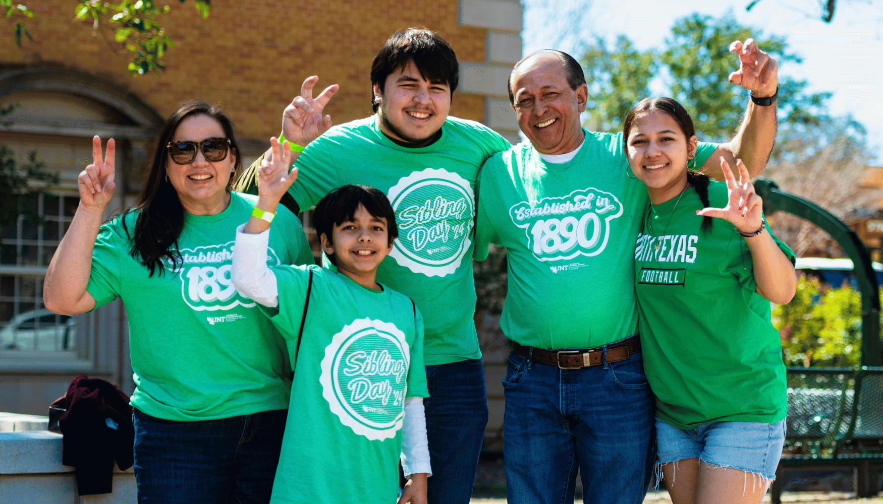 5 unt family members holding eagle claw hand sign