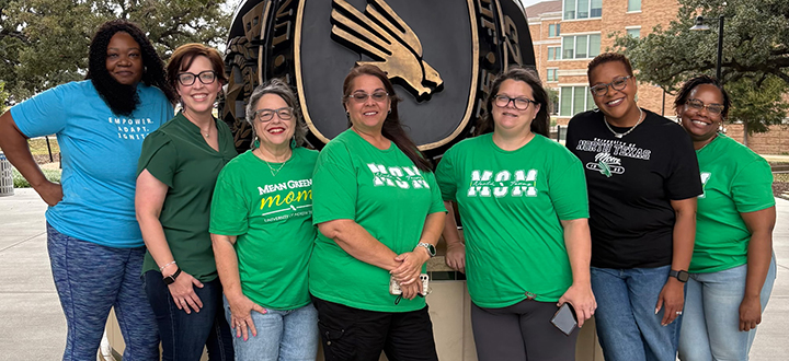 parent association executive board members standing by alumni ring