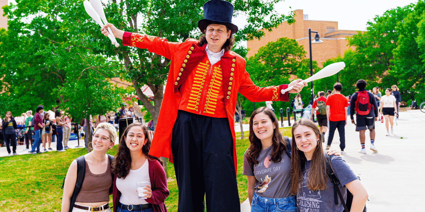 tall carnival man next to 4 students