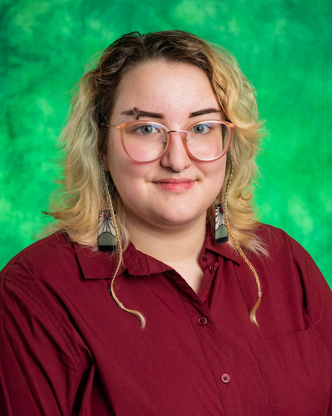 blonde hair, blue eyes, green background