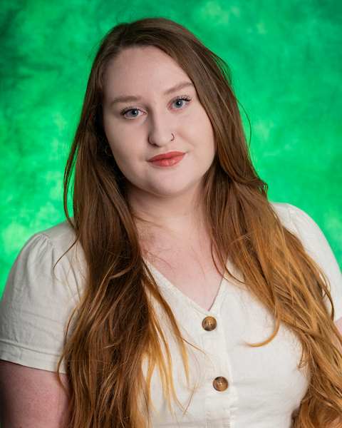 brown hair, green eyes, green background