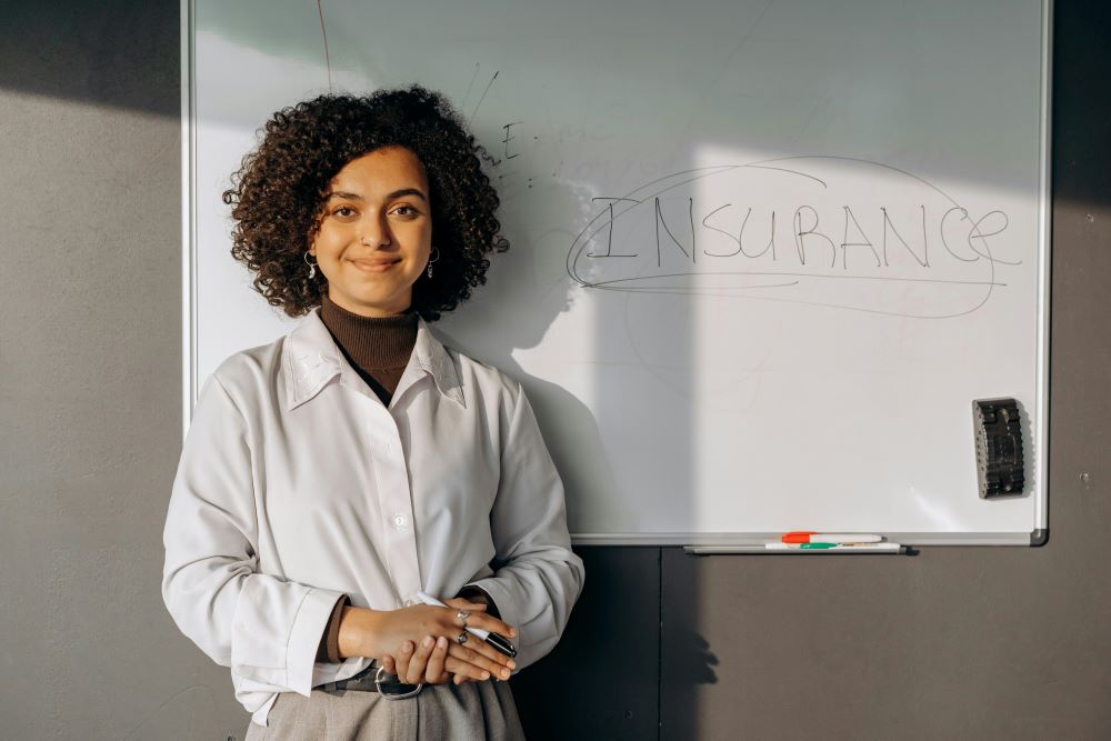 lady standing in front of white board