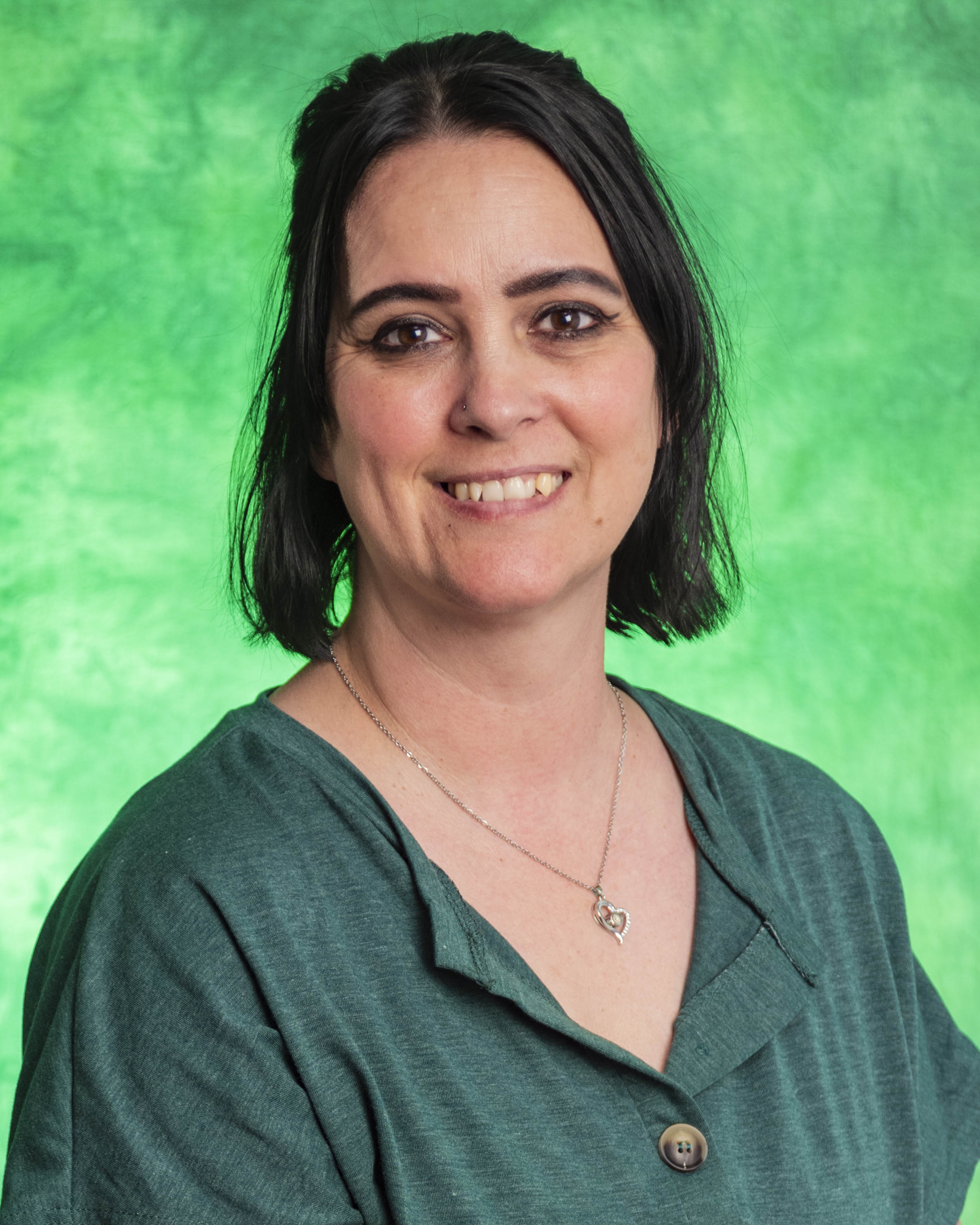 black hair, brown eyes, green background