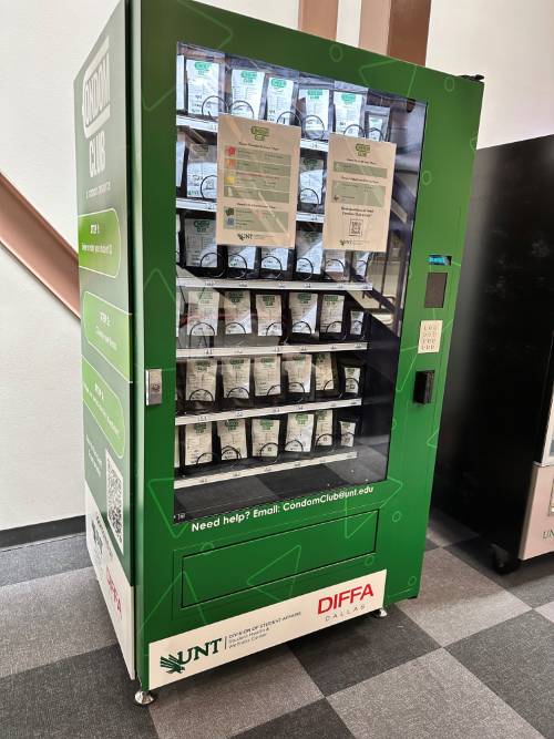 Green vending machine that dispenses safer sex kits.
