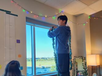 student hanging garland