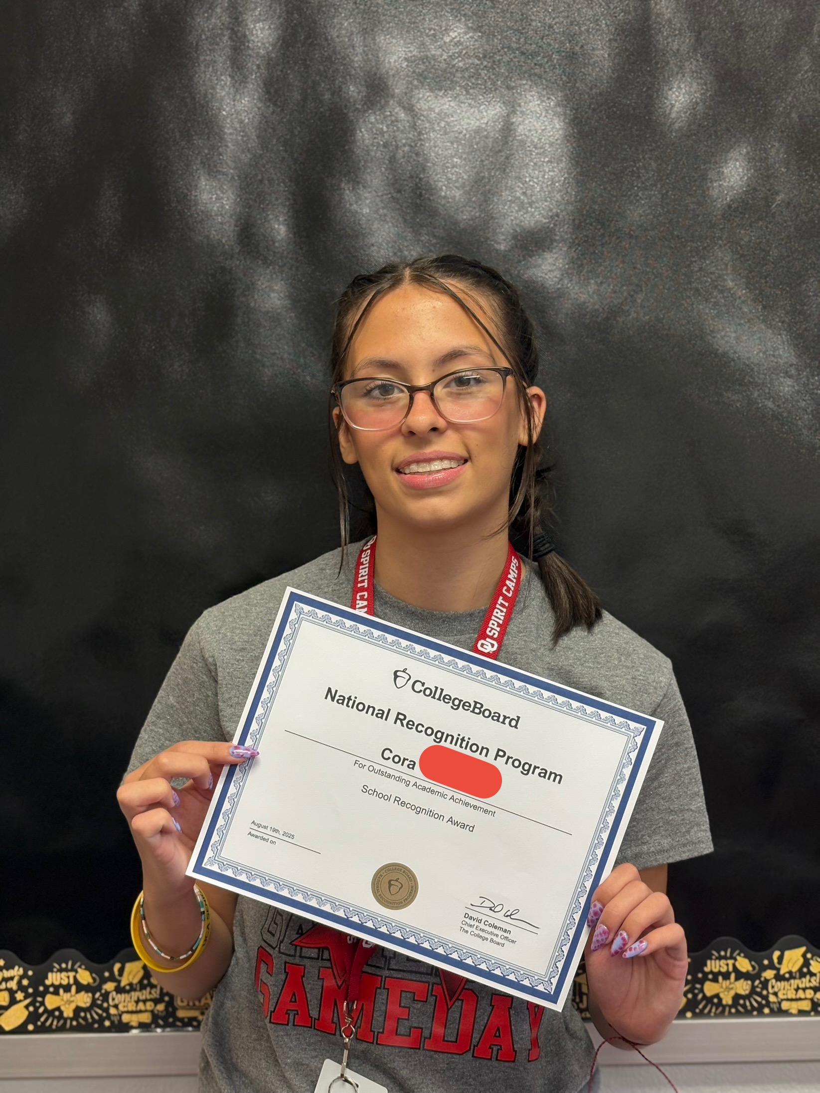 girl holding certificate of award