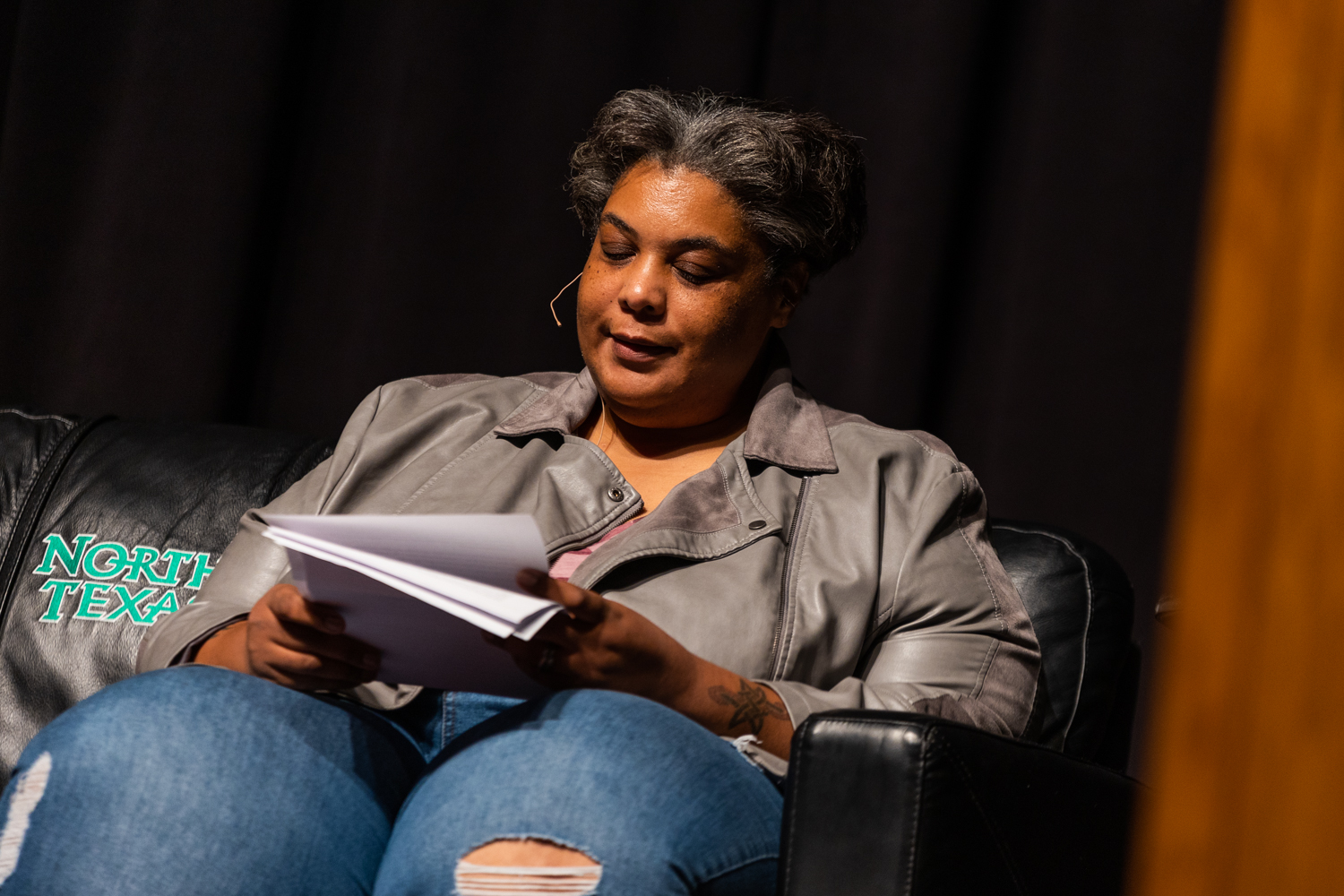 Roxane Gay, a famous author, sitting in a chair while speaking at UNT.